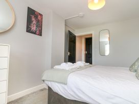 A bedroom with a bed and a mirror at The Pheasantry in Flamborough