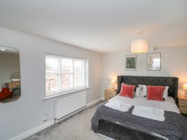 A bedroom with a bed and bedside tables at The Pheasantry in Flamborough