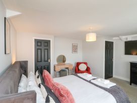 A bedroom with a bed and dressing table at The Pheasantry in Flamborough