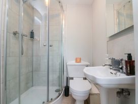 A bathroom with a shower, toilet, and sink at The Pheasantry in Flamborough