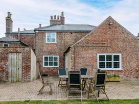 An outdoor patio with a table and chairs at The Pheasantry in Flamborough