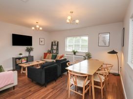 A living room with a television and dining table at The Pheasantry Flamborough