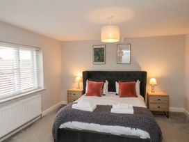 A bedroom with a bed and bedside tables at The Pheasantry in Flamborough