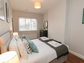 A bedroom with a bed and a mirror at The Pheasantry in Flamborough
