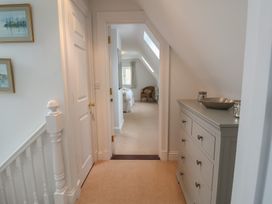 A hallway with a dresser and paintings at 9 Church Farm Rise in Aldeburgh