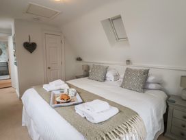 A bedroom with a double bed and side table at 9 Church Farm Rise Aldeburgh