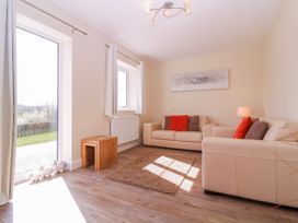 A living room with a sofa and lamp at Country Cottage in Brecon