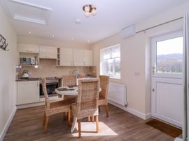 A kitchen with dining table and chairs at Country Cottage Brecon