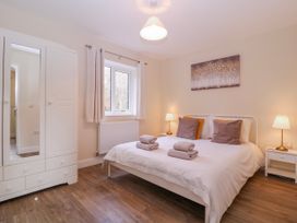 A bedroom with a bed and wardrobe at Country Cottage in Brecon
