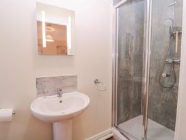 A bathroom with a sink and shower at Country Cottage in Brecon
