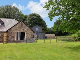 An outdoor space with a house and garden at The Barn in Tafarn-Y-Gelyn