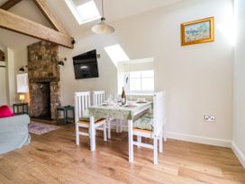 A dining room with a table set for two at The Barn in Tafarn-Y-Gelyn