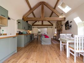 A living room with kitchen and dining area at The Barn Tafarn-Y-Gelyn