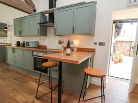 A kitchen with cabinets and a countertop at The Barn in Tafarn-Y-Gelyn