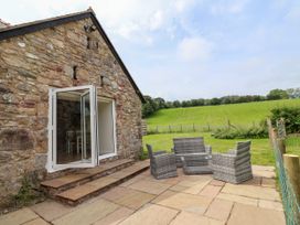An outdoor patio area with garden furniture at The Barn Tafarn-Y-Gelyn