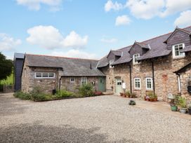 An outdoor area with stone buildings and a gravel driveway at The Barn Tafarn-Y-Gelyn