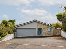 A house with a garage and driveway at 13 Downside Close in Charmouth
