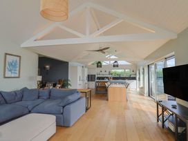 A living room with a sofa and table at 13 Downside Close in Charmouth