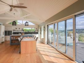 A kitchen with an island and barstools at 13 Downside Close Charmouth