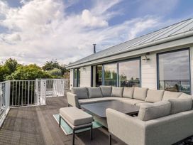 An outdoor living area with a sofa and coffee table at 13 Downside Close in Charmouth