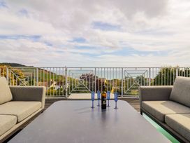 An outdoor seating area with sofas and a table at 13 Downside Close in Charmouth