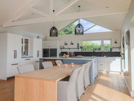A kitchen with a dining table and chairs at 13 Downside Close in Charmouth