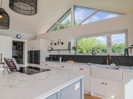 A kitchen with an island and modern appliances at 13 Downside Close in Charmouth