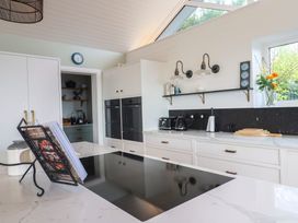 A kitchen with a cooktop and coffee maker at 13 Downside Close Charmouth