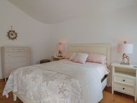A bedroom with a bed and nightstands at 13 Downside Close Charmouth
