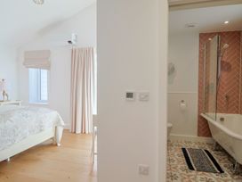 A bedroom with an adjoining bathroom at 13 Downside Close in Charmouth