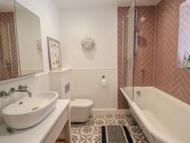 A bathroom with sink, toilet, shower, and bathtub at 13 Downside Close Charmouth