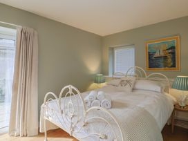 A bedroom with a bed and artwork at 13 Downside Close, Charmouth