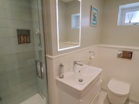 A bathroom with a shower, sink, and toilet at 13 Downside Close Charmouth