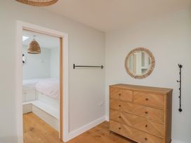 A bedroom with a bed and dresser at 13 Downside Close in Charmouth