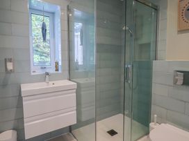 A bathroom with a shower and sink at 13 Downside Close, Charmouth