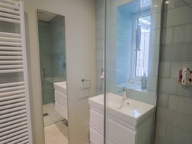 A bathroom with a shower and sink at 13 Downside Close, Charmouth