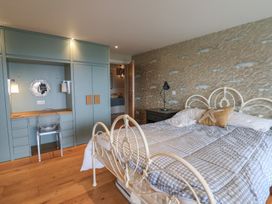 A bedroom with a bed and desk at 13 Downside Close, Charmouth