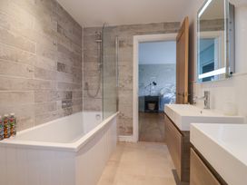 A bathroom with a bathtub and sink at 13 Downside Close in Charmouth