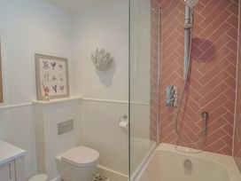 A bathroom with a shower and a toilet at 13 Downside Close in Charmouth