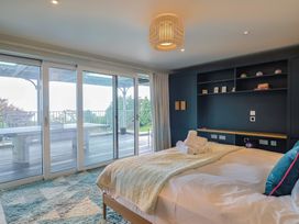 A bedroom with a bed and towels at 13 Downside Close in Charmouth