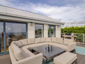 An outdoor patio with a sofa and a table at 13 Downside Close in Charmouth