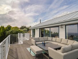 An outdoor seating area with a sectional sofa and table at 13 Downside Close in Charmouth