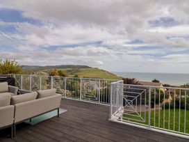 An outdoor area with seating and sea view at 13 Downside Close in Charmouth