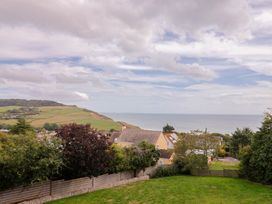 A view of houses and sea from a garden at 13 Downside Close in Charmouth