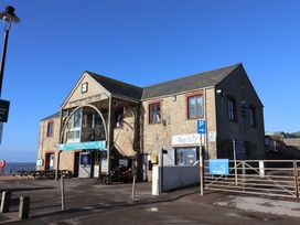 A building with signage and bike at 13 Downside Close in Charmouth