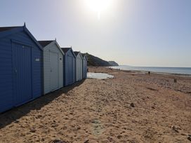 Beach huts along a sandy beach at 13 Downside Close Charmouth