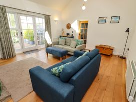 A living room with a sofa and ottoman at Little Tern in Seahouses
