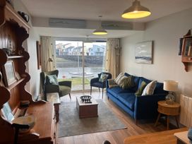 A living room with a sofa and coffee table at 9 Oakley Wharf in Porthmadog