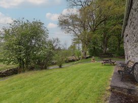 An outdoor area with a bench and picnic table at The Long House in Penmachno