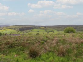 A landscape with fields and hills at The Long House in Penmachno